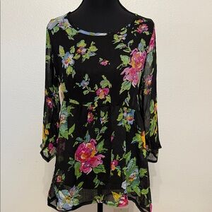A whimsical sheer floral blouse by about a girl.